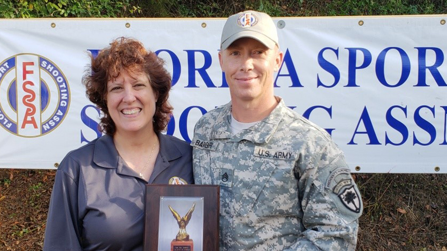 Sue Carter congratulates Florida Pistol State Champion Tim Barber