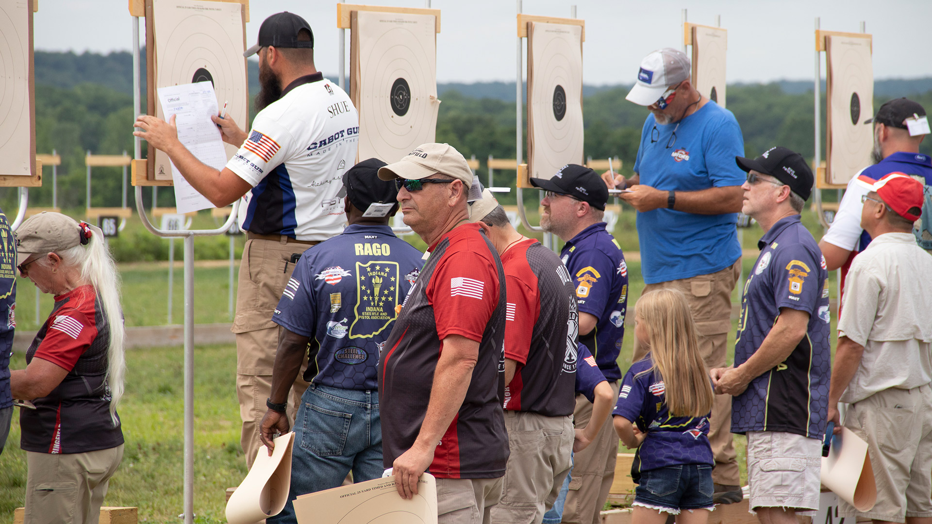 Pistol competitors change targets